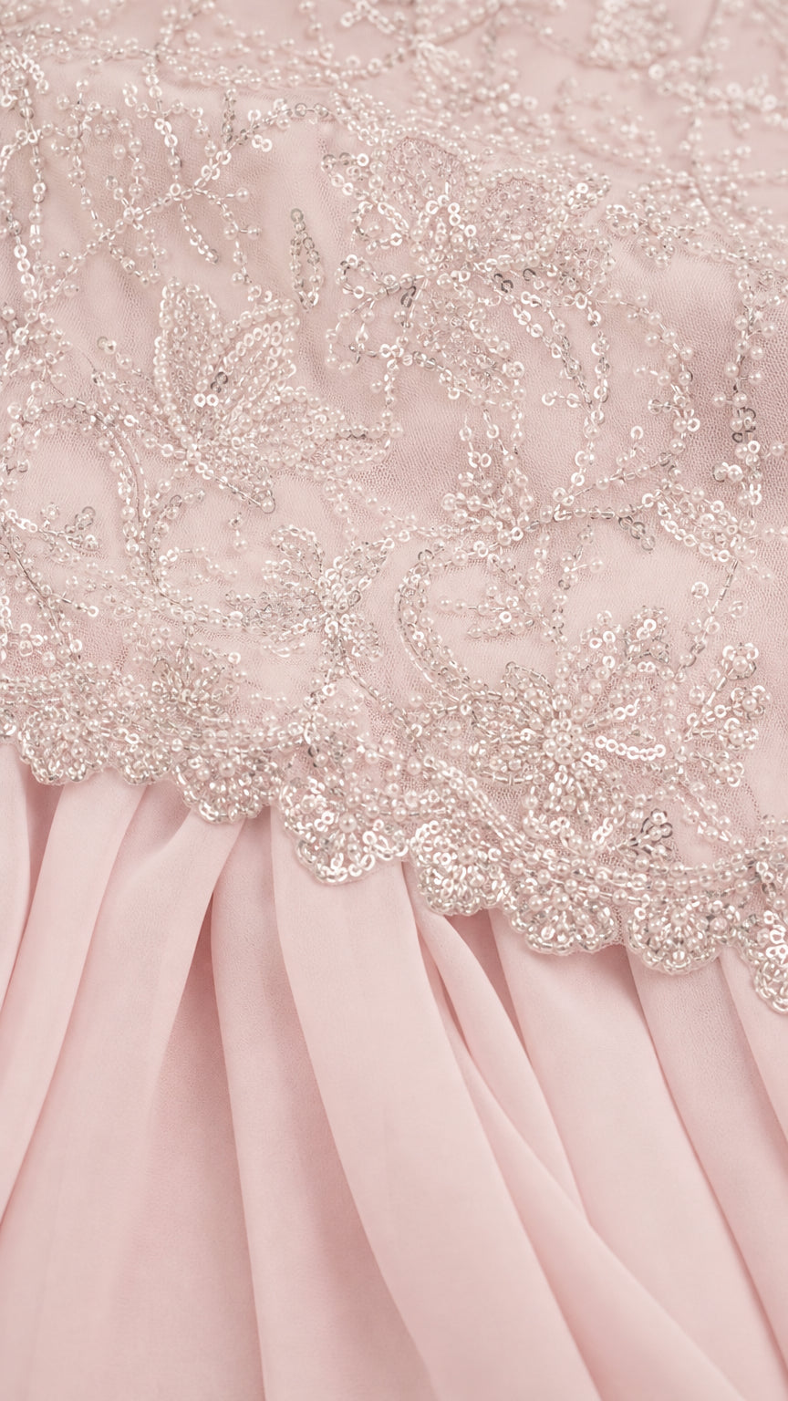 Close-up detail of delicate floral sequin embroidery on bodice hem