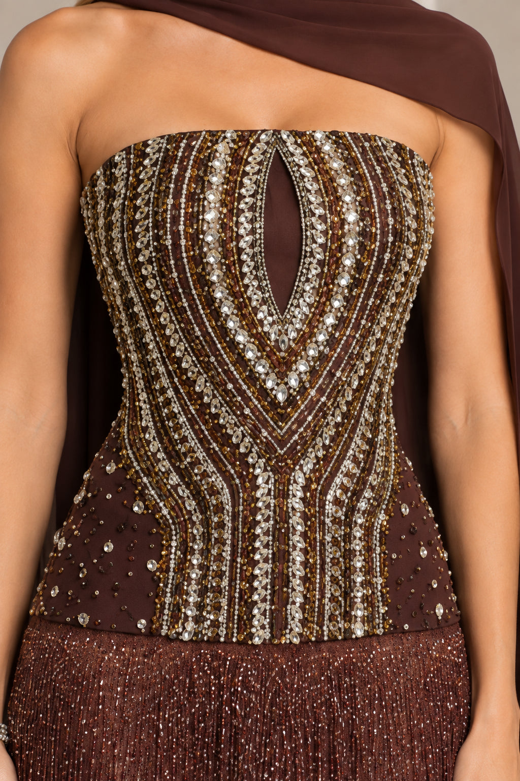 Close up of intricate beadwork and crystal detailing on corset bodice