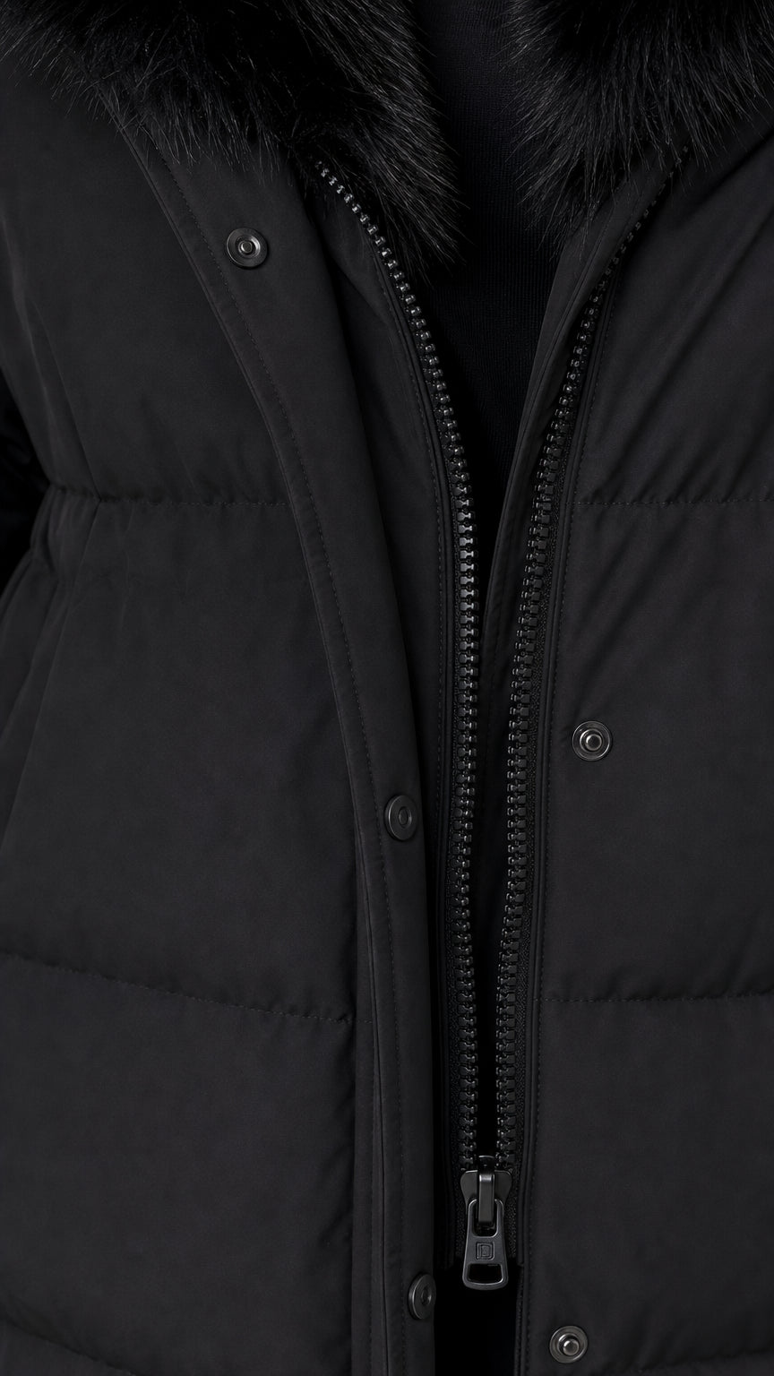 Close up of black winter coat zipper closure and snap button storm placket