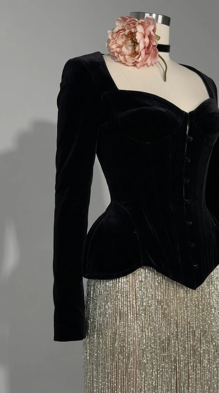 Close-up detail of black velvet corset sweetheart neckline and structured seams