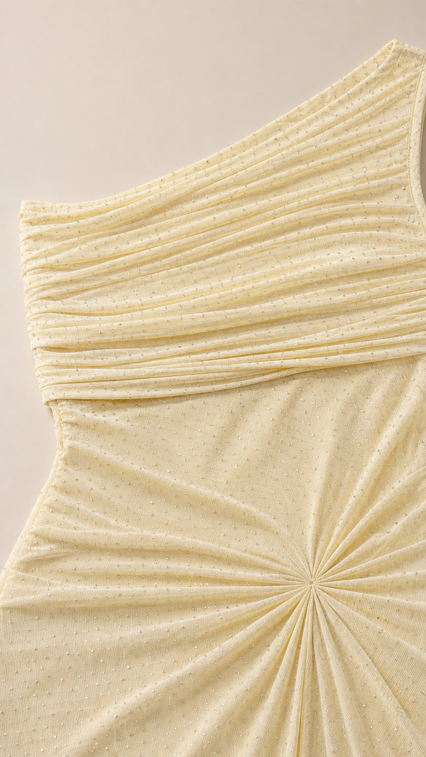 Close-up of butter yellow shimmer fabric and radial waist pleating