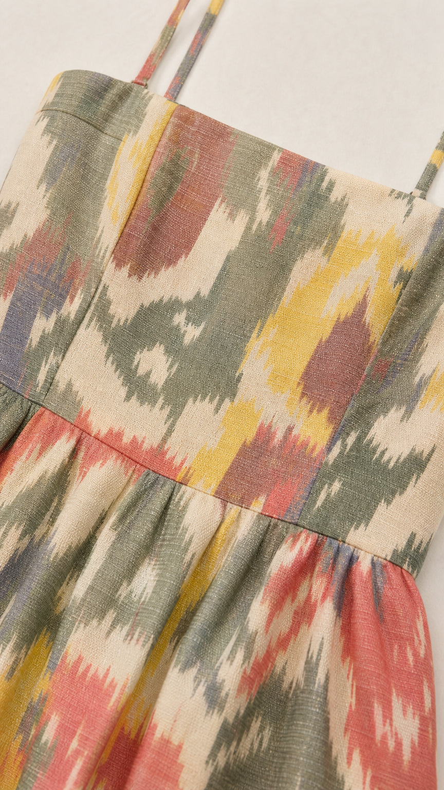 Close-up detail of textured woven fabric with colorful ikat print