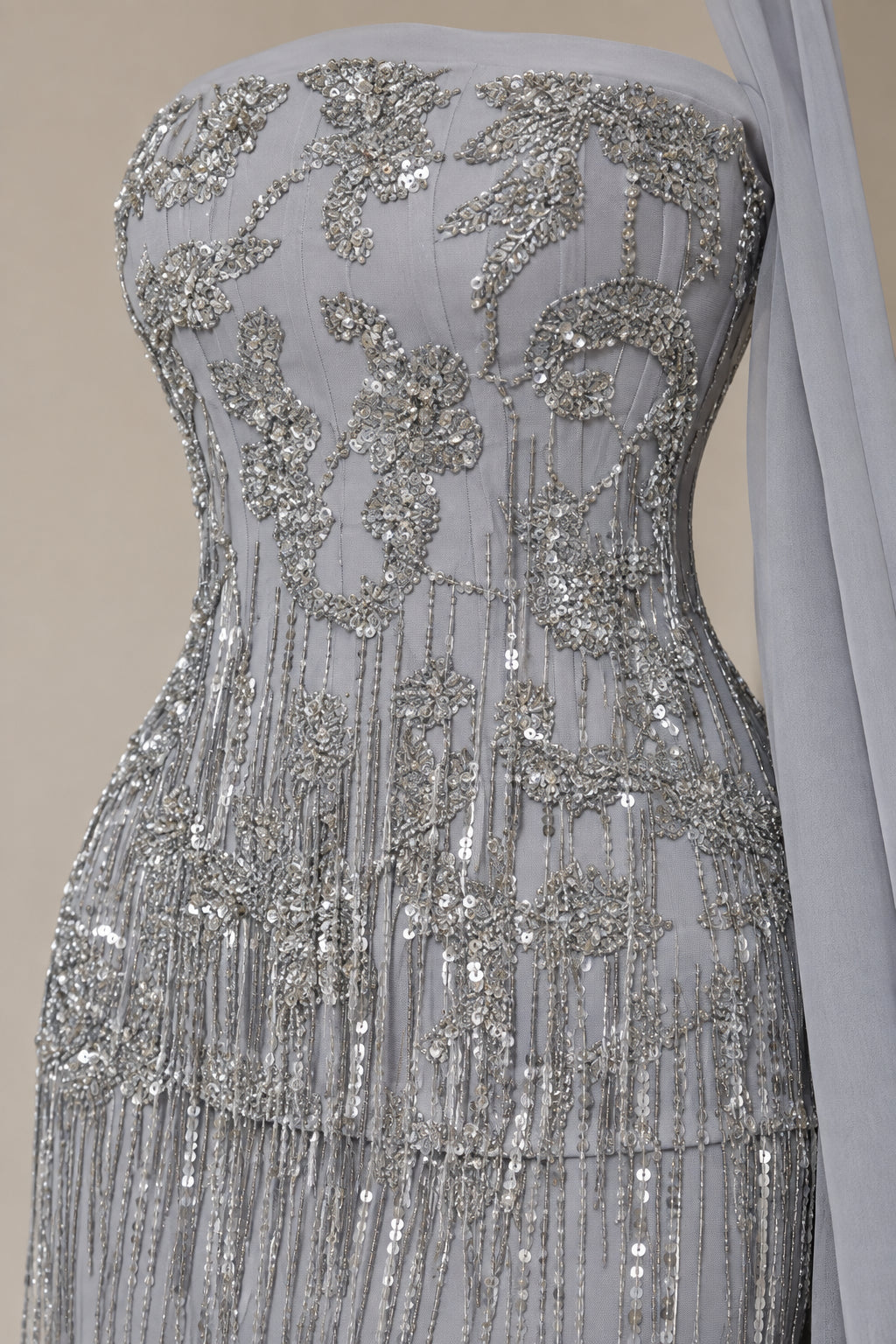 Close-up detail of intricate sequin embroidery and beaded fringe on Silver Grey gown bodice