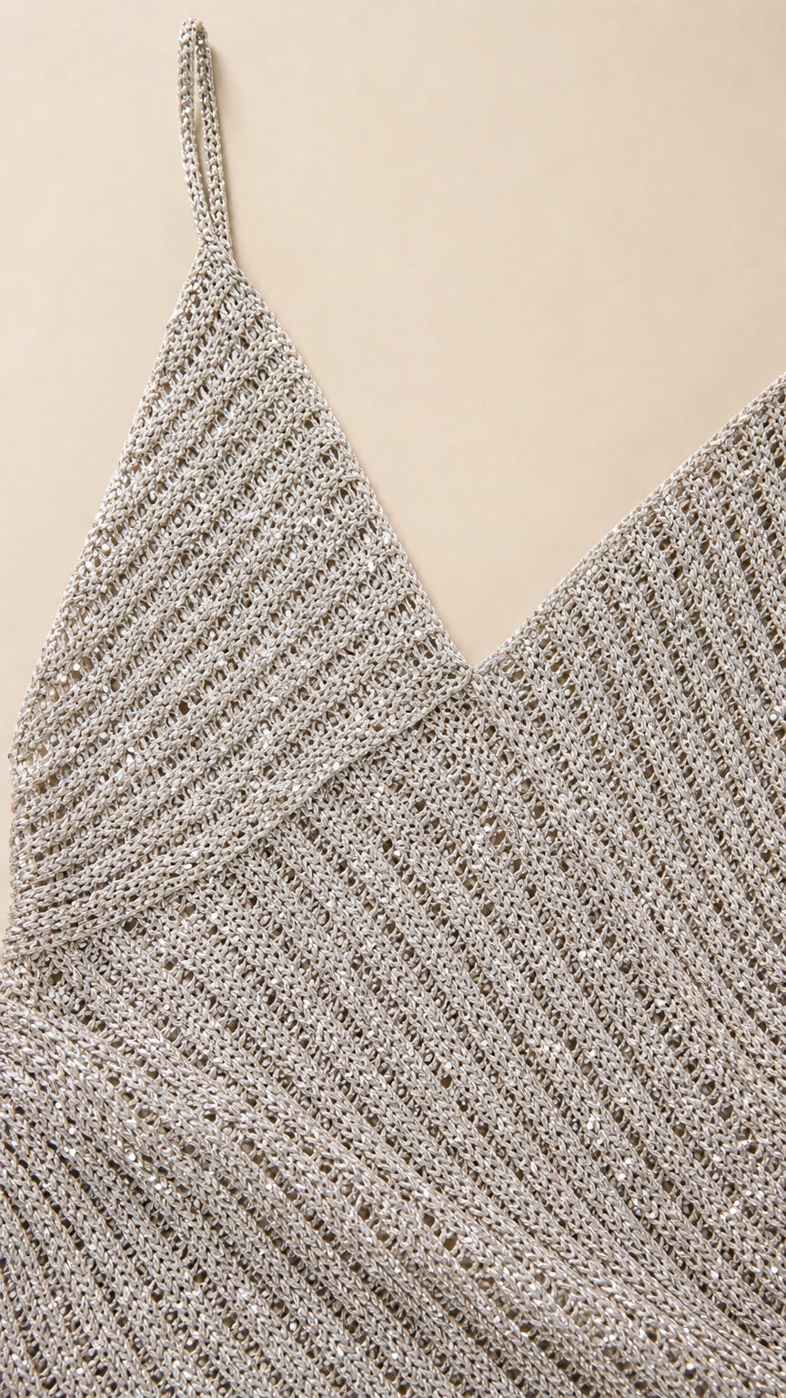 Close-up detail of textured metallic ribbed knit fabric and neckline