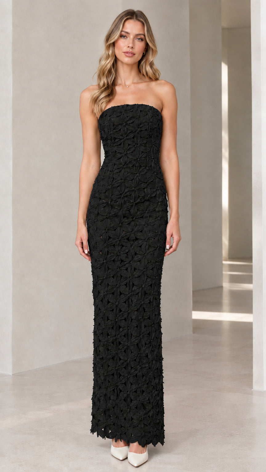 Full-length front view of black strapless 3D floral textured maxi dress