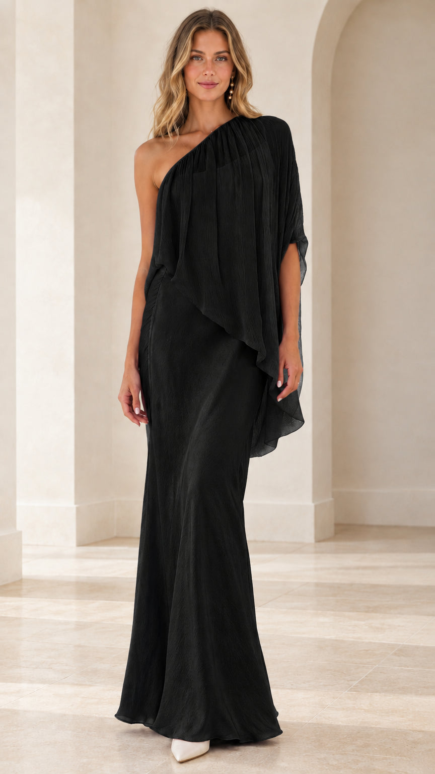 Model wearing black one-shoulder draped cape evening maxi dress