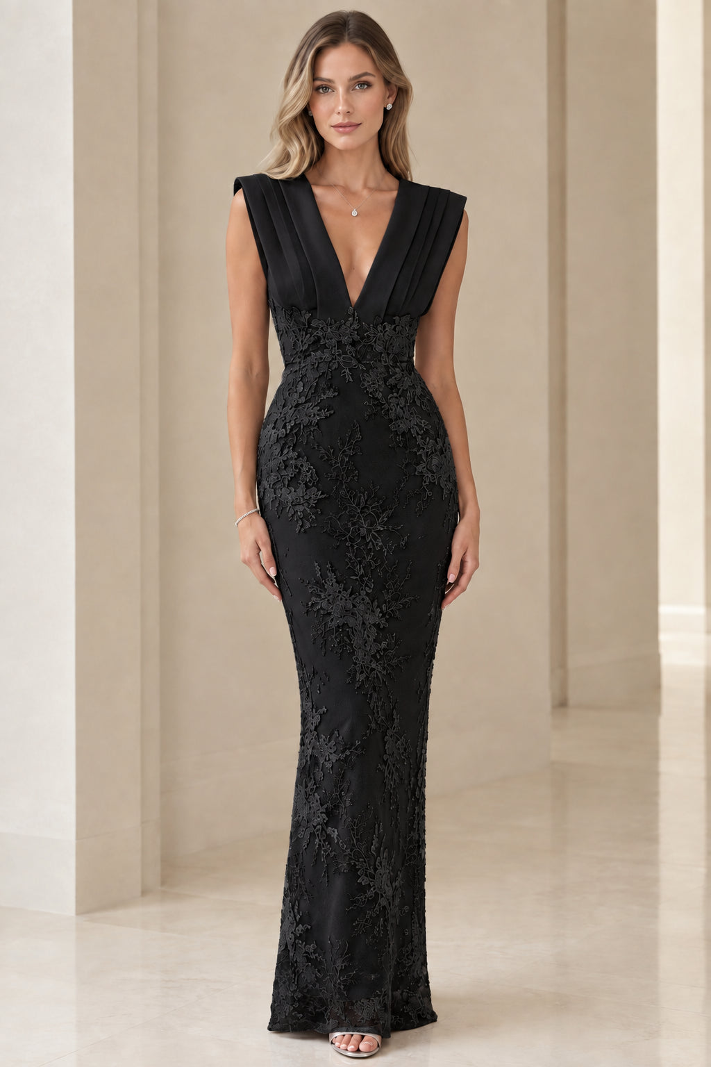 Model wearing black corded lace pleated V-neck evening maxi gown