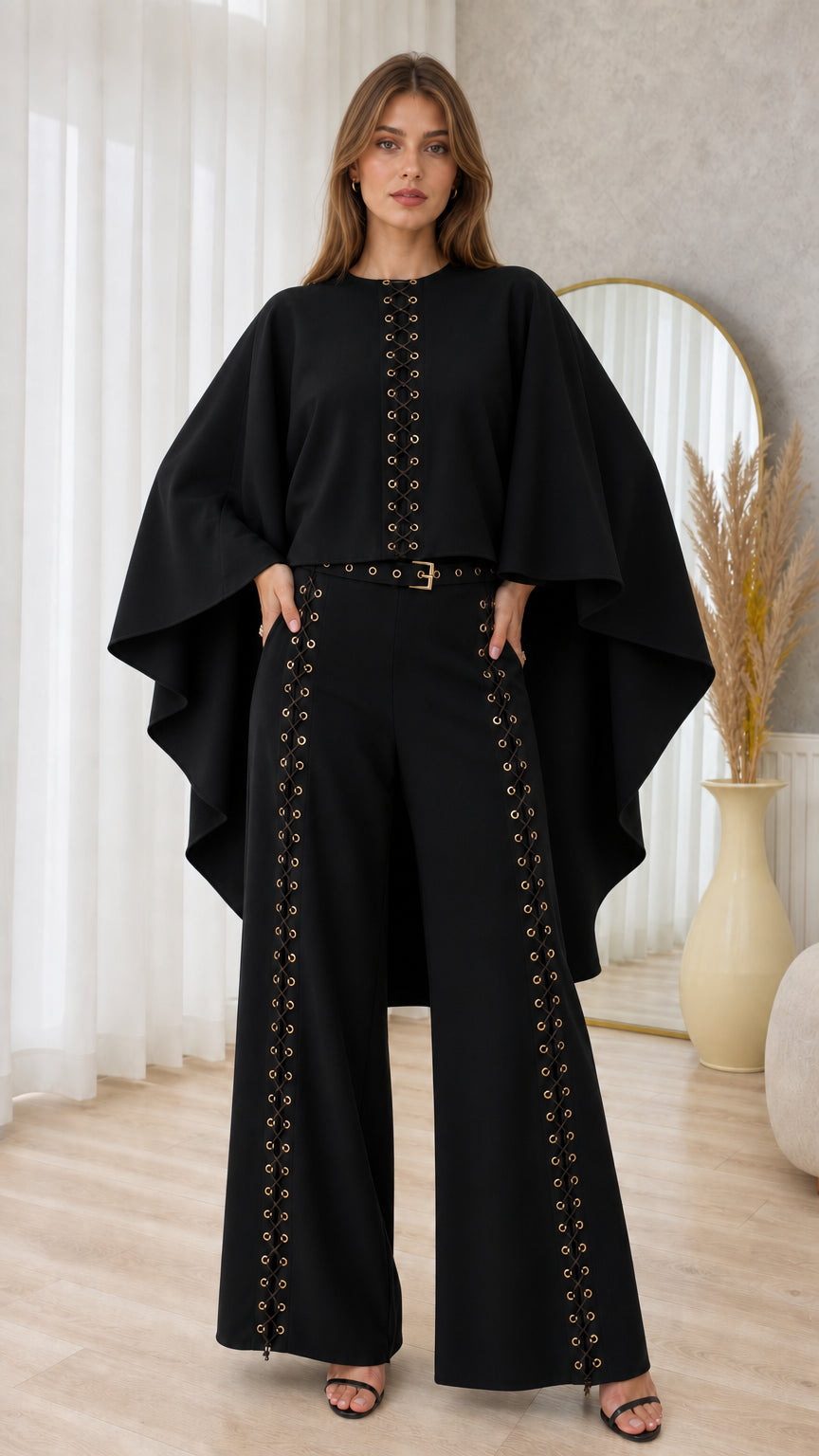 Front full-length view of black cape sleeve top and matching grommet wide-leg pants set