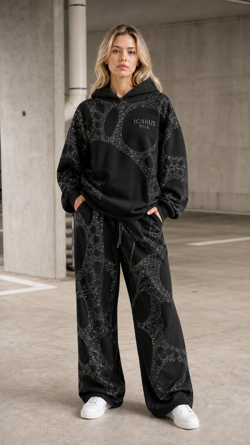 Front view of model wearing black rhinestone hoodie and pants set