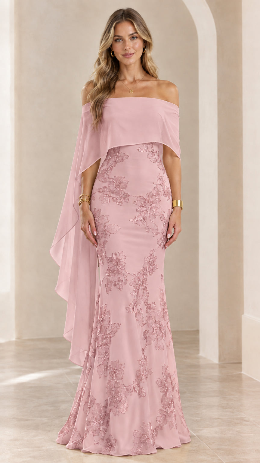 Woman wearing blush pink off-the-shoulder embroidered cape evening gown