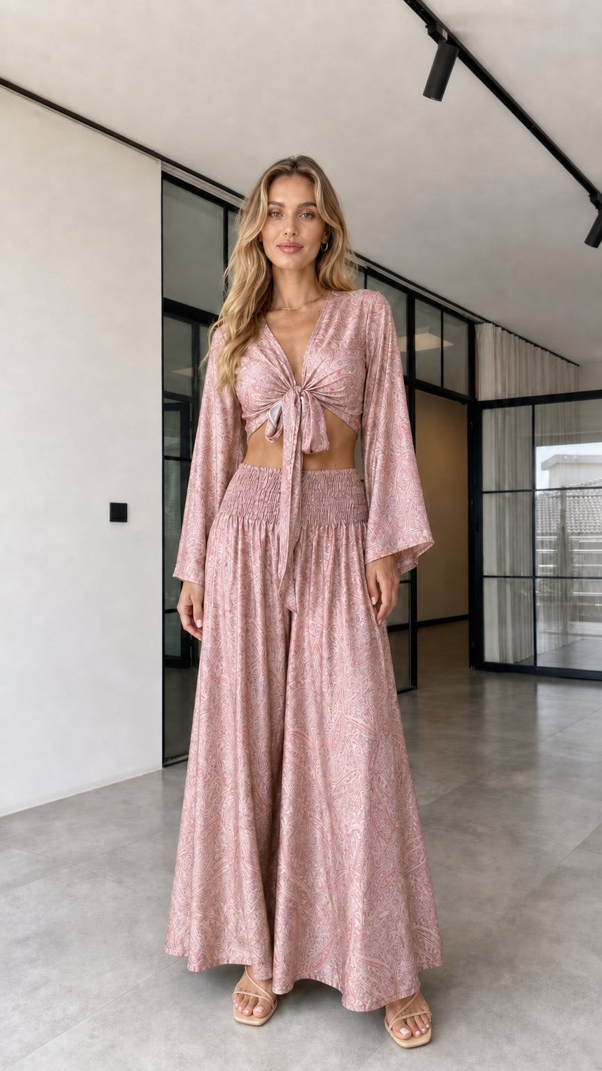 Model wearing the dusty rose paisley-inspired tie-front crop top and wide-leg pants set