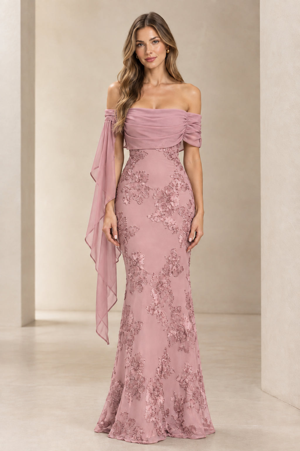 Model wearing dusty rose pink off-the-shoulder embroidered lace evening maxi dress