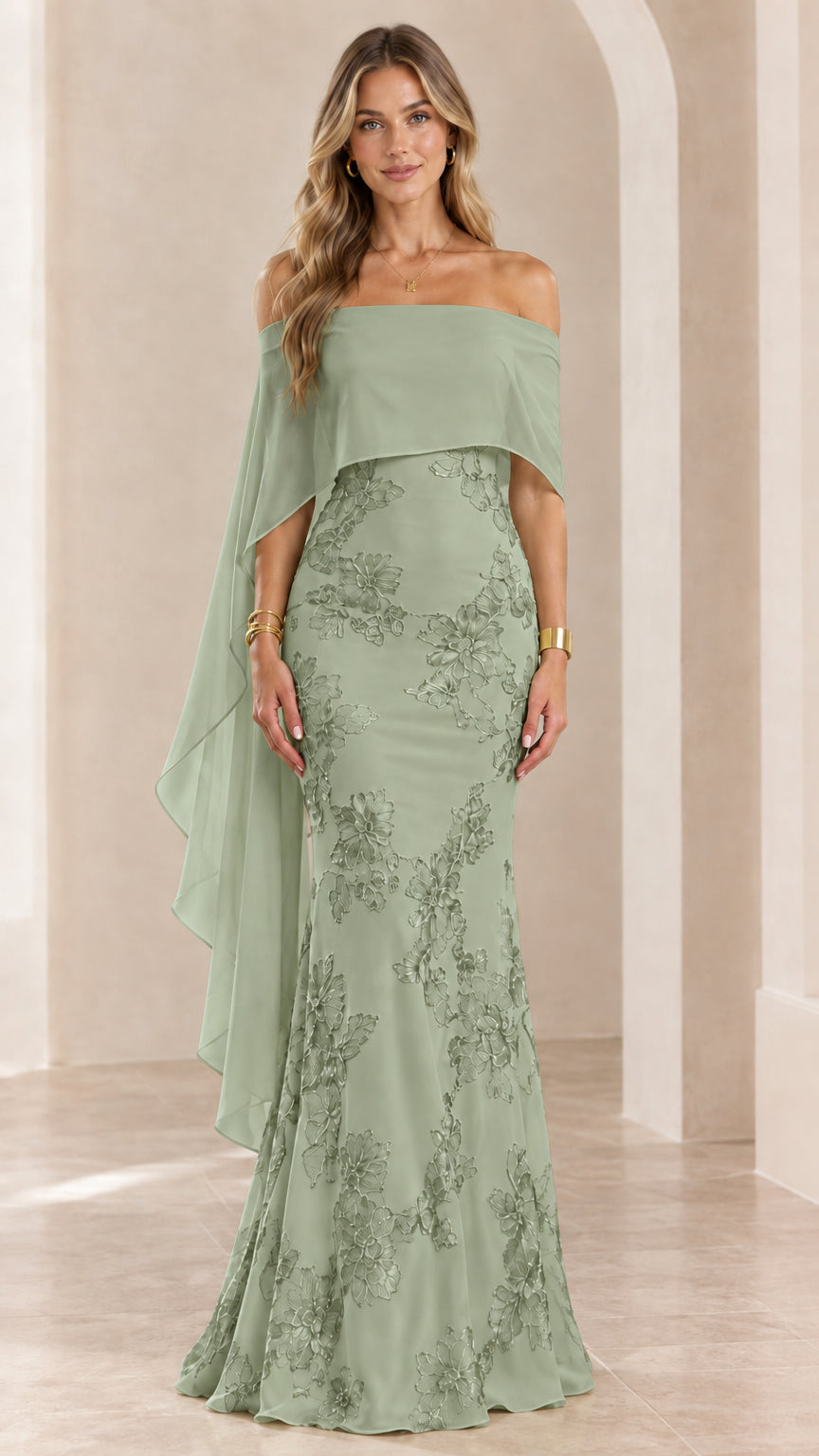 Woman wearing sage green off-the-shoulder embroidered cape evening gown