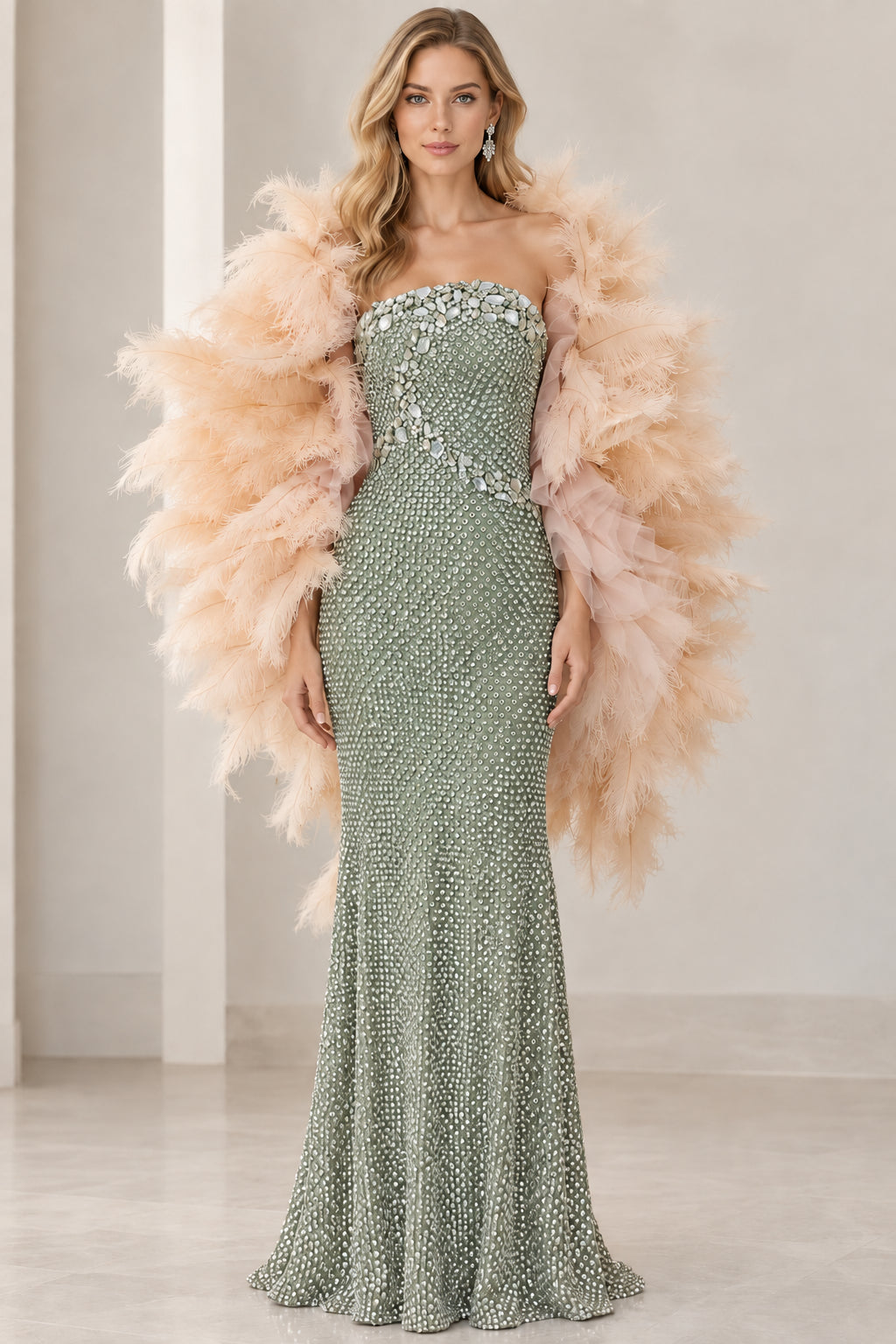 Front view of sage green strapless rhinestone evening dress with statement feather boa wrap