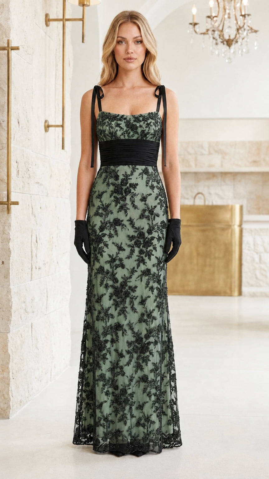 Model wearing black floral lace evening gown with sage green lining