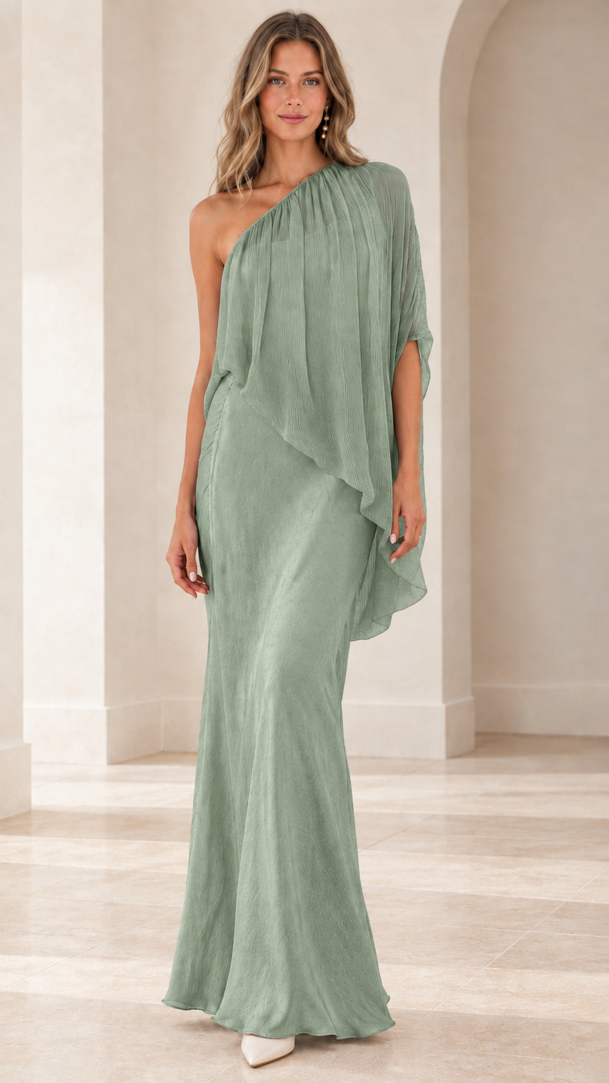 Model wearing sage green one-shoulder draped cape maxi dress