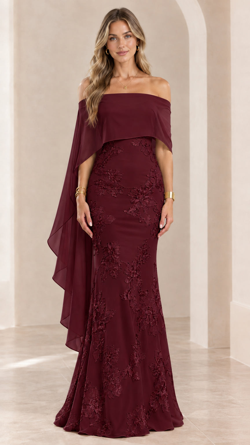 Woman wearing burgundy wine off-the-shoulder embroidered cape evening gown