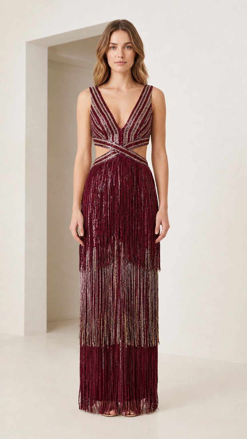 Front view of burgundy wine tiered metallic fringe cutout maxi gown