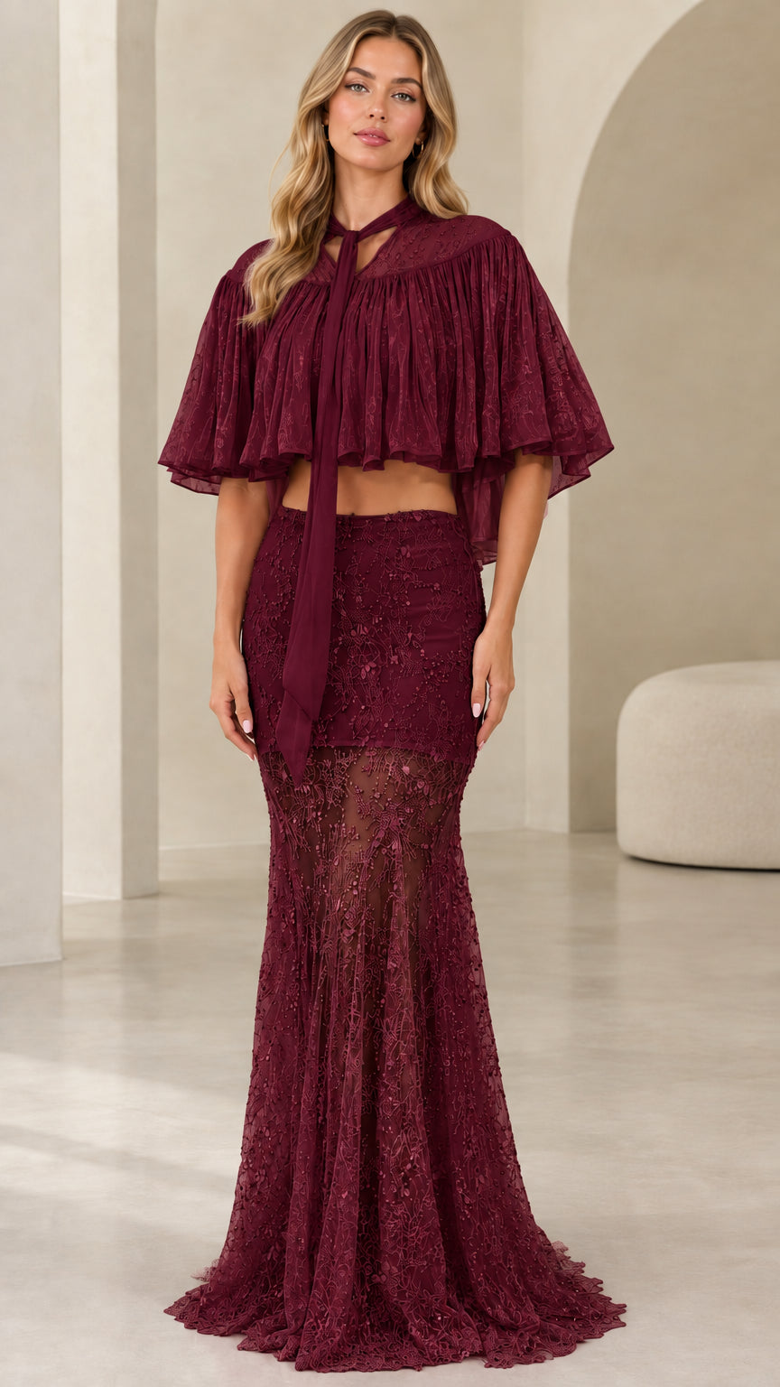 Model wearing burgundy wine sequined two-piece evening set with neck-tie capelet