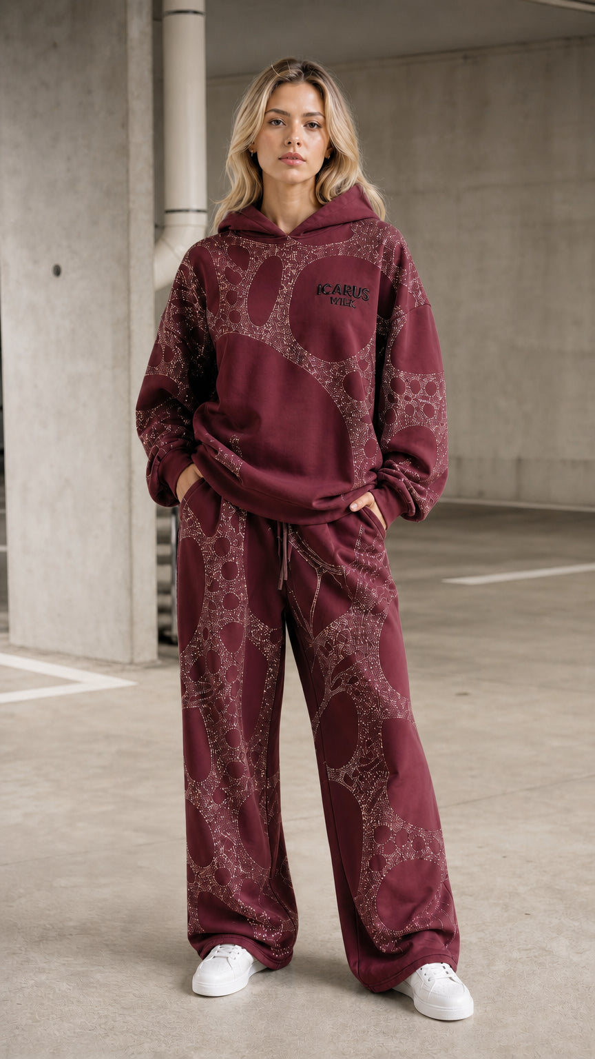 Front view of model wearing burgundy rhinestone hoodie and pants set