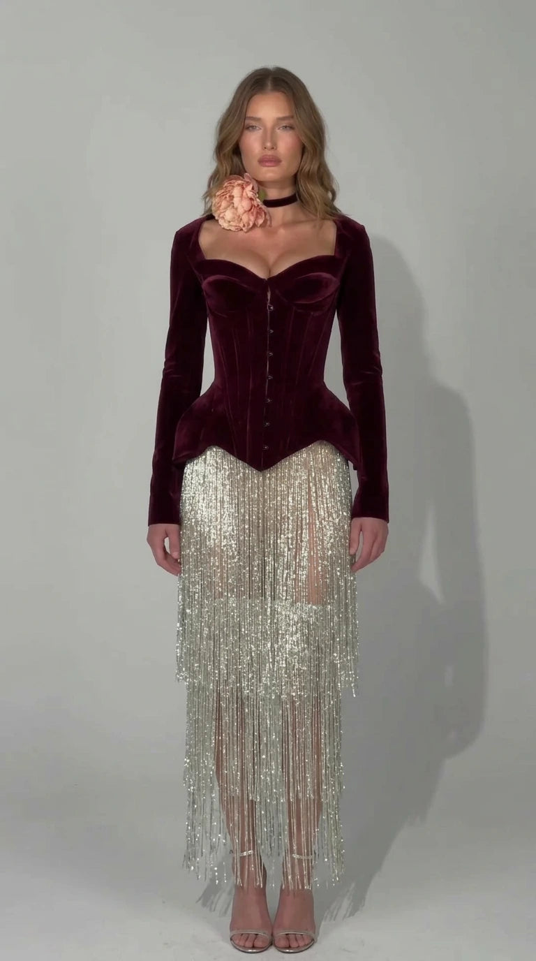 Front view of rich burgundy wine velvet corset dress with silver fringe skirt