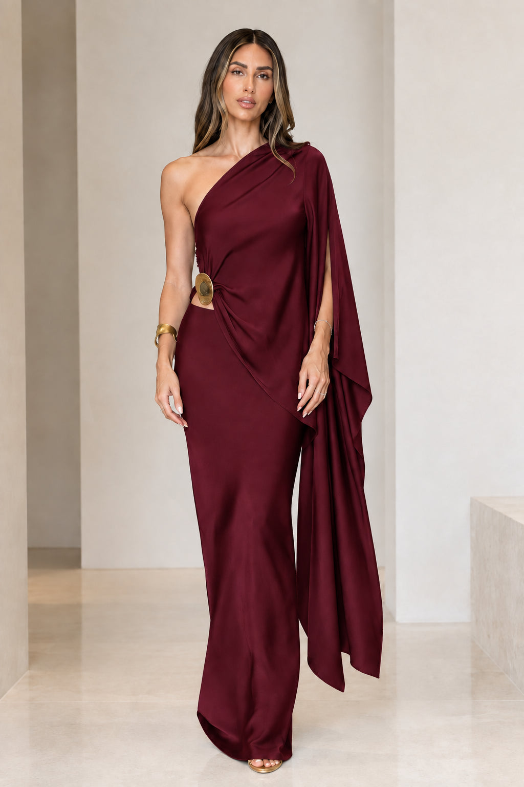 Front view of model wearing burgundy wine red one-shoulder draped satin evening gown