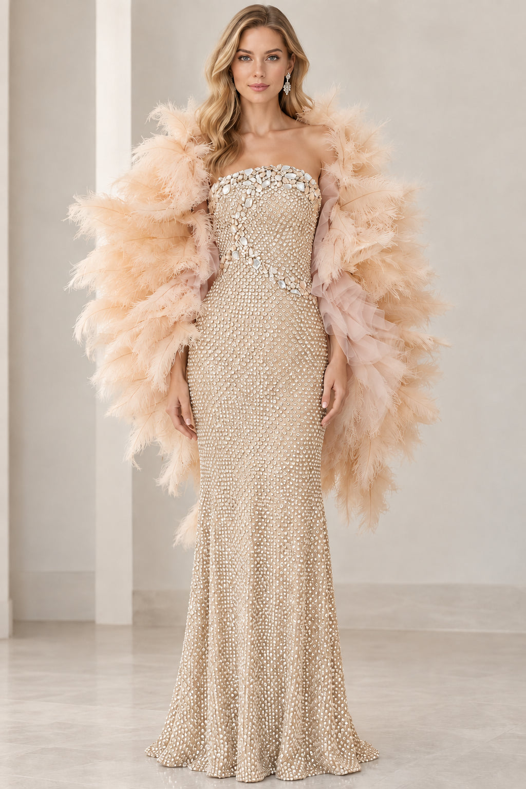 Front view of champagne gold strapless rhinestone floor-length evening dress with feather wrap