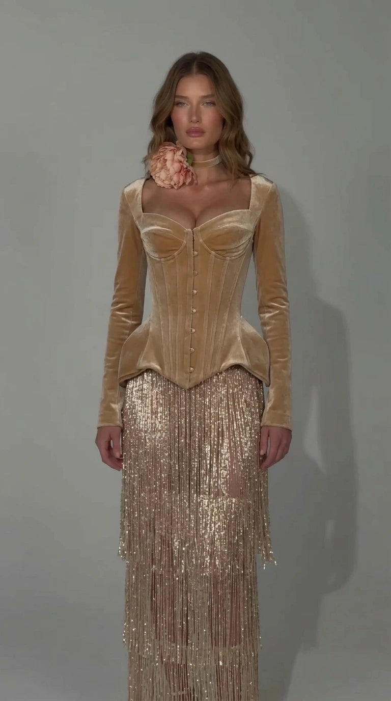 Front view of champagne gold velvet corset evening dress with glittering fringe skirt