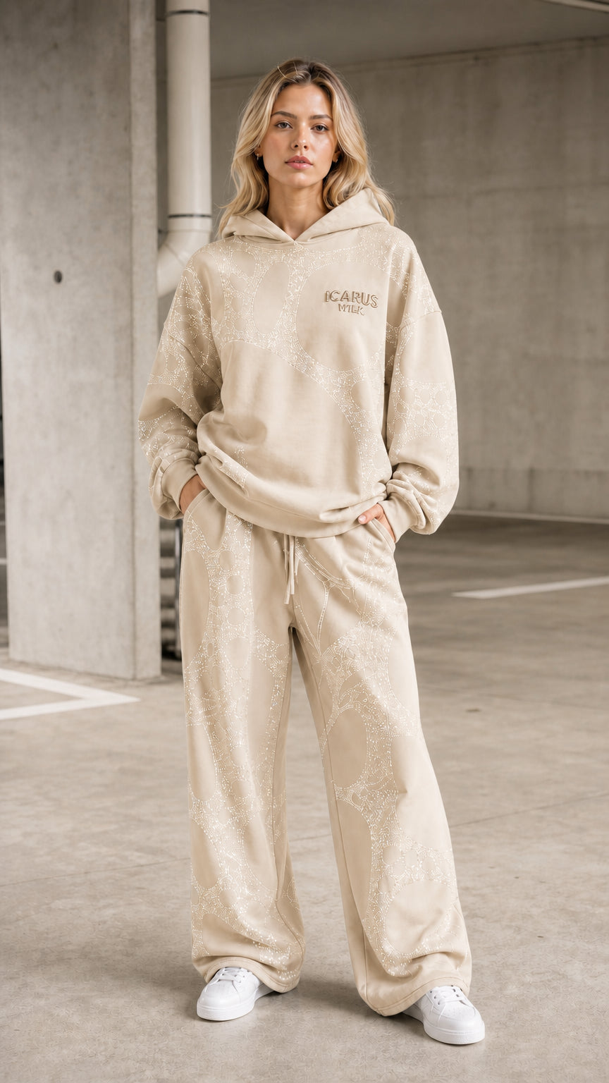Front view of model wearing beige rhinestone hoodie and pants set